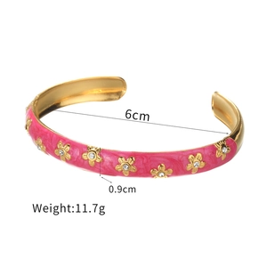 Gold C-shape stainless steel open cuff with rose red enamel and crystal flower detail