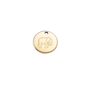 Macro detail of a round 18K gold-plated titanium steel pendant with elephant engraving
