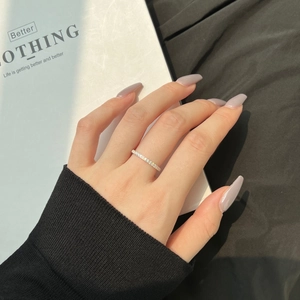 Close-up of a minimalist S925 sterling silver eternity ring with pave-set sparkling zircons