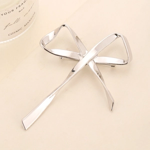 Elegant silver metal bow brooch with a sleek, polished surface for women's apparel