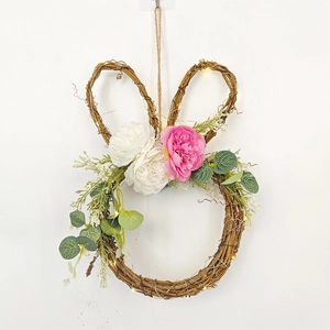 Easter bunny wreath with rattan vines, faux flowers, and warm LED lights for door decor