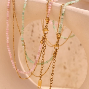Detail of 18K gold-plated double-layer necklace with pink and green beads and lobster clasp