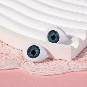 Detail of 14x19mm boat-shaped blue acrylic doll eyes with realistic iris texture