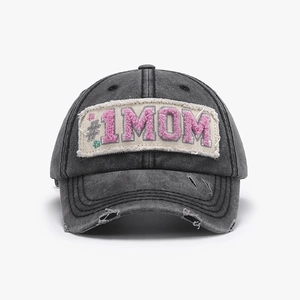 Detail of washed grey baseball cap featuring pink #1 MOM towel embroidery patch