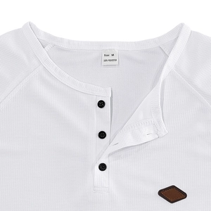 Macro detail of white waffle knit fabric, Henley neckline and brand-less size label