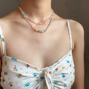 Detail of a double-layered colorful beaded necklace with elegant cat-eye stone accents