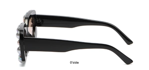Side view of square black sunglasses featuring large white pearls and colorful rhinestones