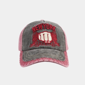 Detail of vintage washed cotton baseball cap with New York fist embroidery and distressed brim