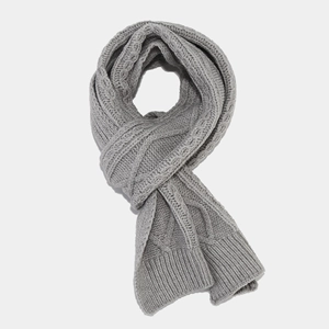 Close-up of gray cable knit scarf texture showing thick warm knitted pattern
