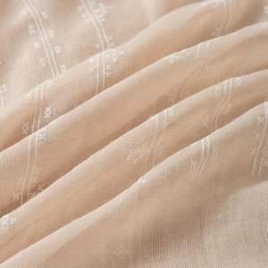 Detailed macro view of beige cotton linen fabric showing fine white stripes and cross patterns