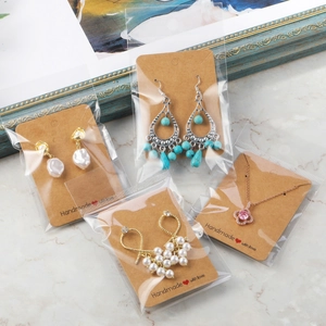 Detail of jewelry set on Handmade with Love kraft cards including pearl earrings and necklace