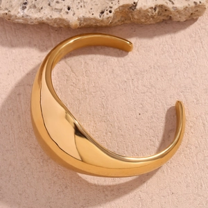 Top view of chunky 18K gold plated stainless steel open bangle with glossy curved design