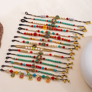 Bracelet tressé ethnique avec perles colorées et cloches vintage de style tibétain