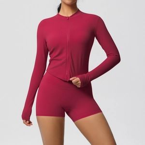 Detail view of dark red yoga set showing thumb holes and double-sided brushed fabric texture