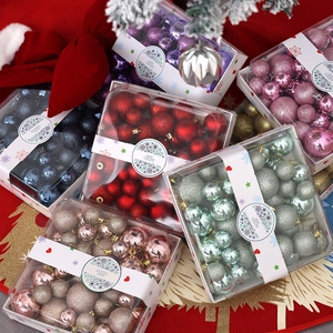 Close-up of stacked colorful Christmas ornament sets with glitter and matte finishes
