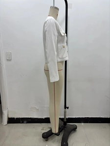 Detailed side view of white fitted jacket with decorative gold buttons and flap pockets