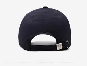 Detail view of adjustable back strap and silver metal buckle on a black baseball cap