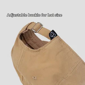 Detail of adjustable metal buckle and black woven label on cotton baseball cap