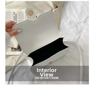 Detail of the white crossbody bag interior with magnetic closure and wavy flap design