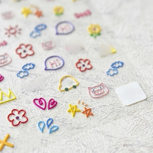 Detailed macro view of 5D embossed nail stickers with colorful doodle designs