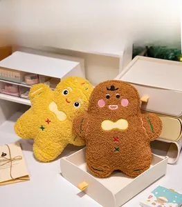 Detail of embroidered gingerbread man plush toys in textured fleece with festive bows
