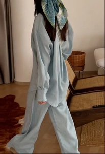 Detailed texture of light blue casual two-piece linen set with loose shirt and pants