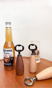 Close-up of walnut and beech wood magnetic bottle openers on a rustic wooden tray