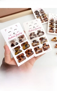 Close-up of 8-piece mini leopard print hair claws set on a retail display card