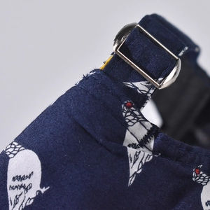 Detailed view of dark blue baseball cap with silver adjustable metal buckle and stitching