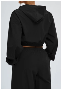 Rear view of black windproof hooded sun protection sports suit with cropped waist design