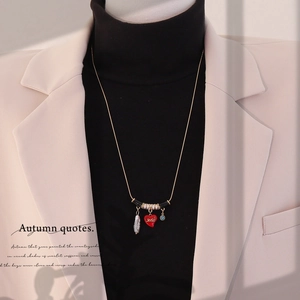 Gold long chain necklace with red enamel heart, pearl, and blue rhinestone pendants