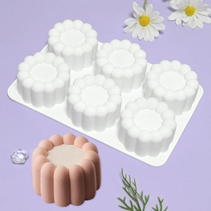 Detailed view of white 6-cavity silicone mousse mold with pink petal-shaped cake