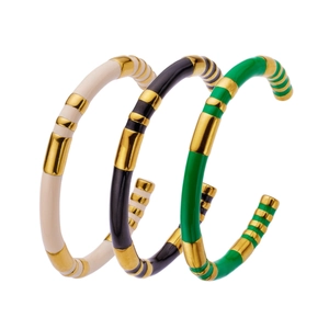 Three-piece gold-plated stainless steel open bangles in white, black, and green enamel