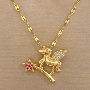 Macro detail of gold unicorn and star pendant with sparkling cubic zirconia inlay