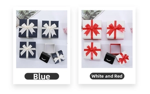 Detail of square jewelry gift boxes with satin bows and black velvet inserts in blue and white