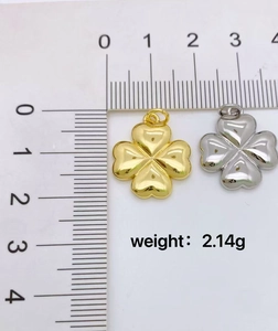 Detailed size view of gold and silver clover pendants showing 1.8cm width and 2.14g weight