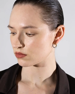 Close-up of dual-tone 18K gold and silver hoop earrings with unique balloon wrinkle texture