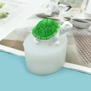 Close-up of 3D turtle silicone mold with finished green resin tortoise craft