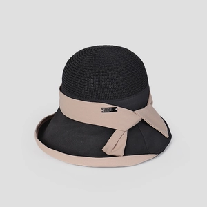 Close-up detail of an elegant black and beige round top breathable sun hat for women