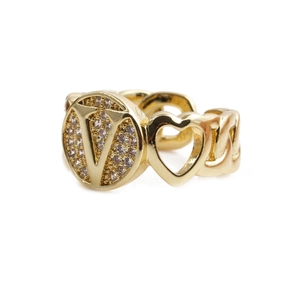 Macro detail of gold letter V heart ring with sparkling stones and chain band design