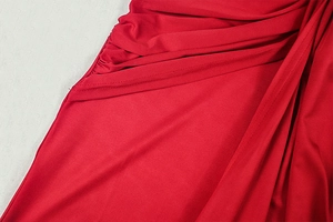Detailed view of red ruched fabric texture with high-quality stitching and elastic material