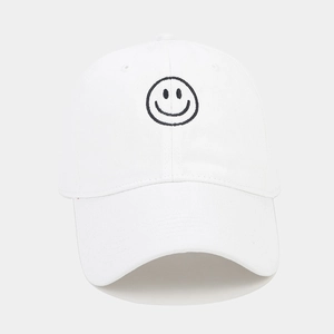 Close-up of black smiley face embroidery on white cotton twill baseball cap with curved brim