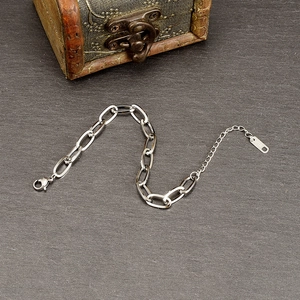 Silver minimalist chunky link bracelet in 18K gold plated steel on dark stone background