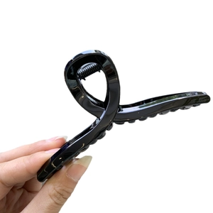 Glossy black 11cm hair claw clip with twisted design shown against a white background