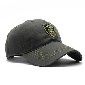 Close-up of military-style shield embroidery on camouflage cotton baseball cap