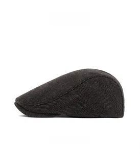 Side view of dark grey herringbone wool newsboy cap with premium texture detail