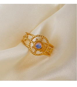Detailed macro view of an 18K gold-plated vintage ring featuring an iridescent opal-like stone