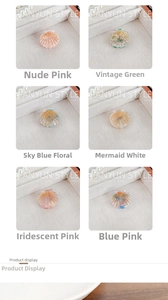 Detail showing six colors of shell shaped acetate hair clips with gold metal wire accent