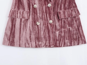 Detailed macro shot of dust pink velvet blazer fabric with silver pattern buttons