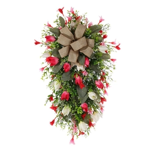 Artificial tulip Christmas swag with red and white flowers and a brown burlap bow